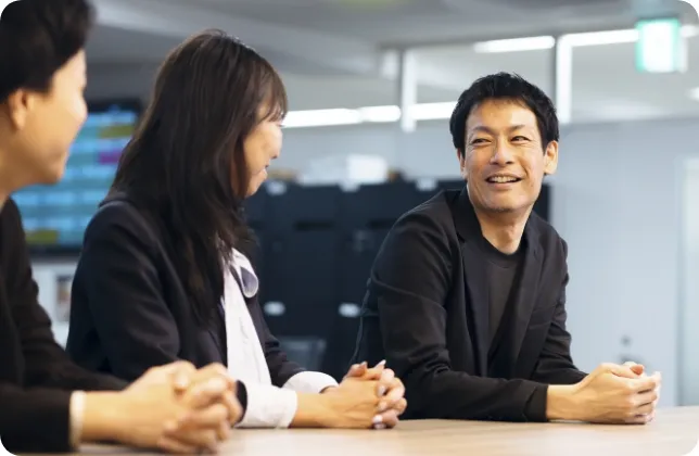 3人が横に並び椅子に座って話している様子